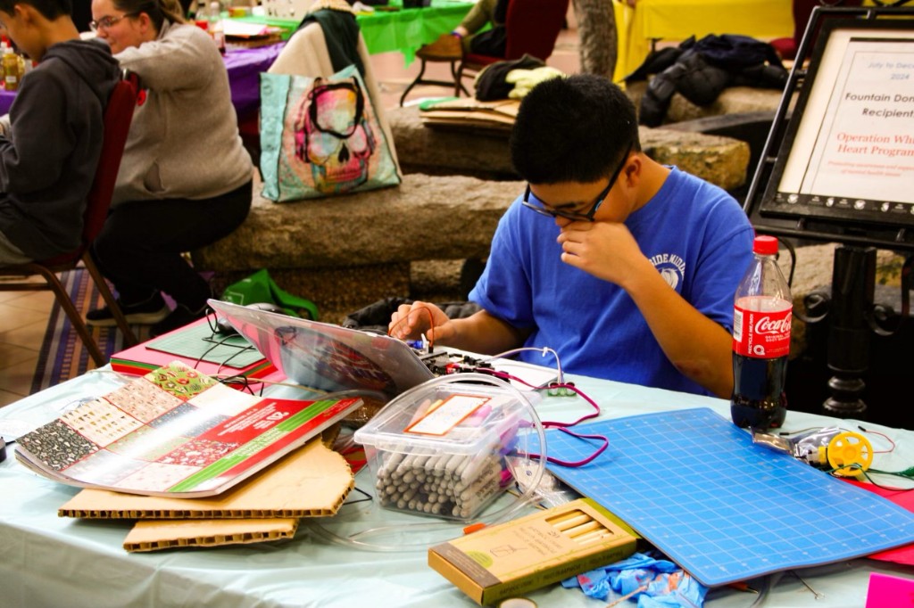 Participant working on project at Cardboard for Kitty
